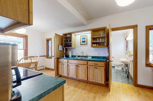 a kitchen with a sink and a counter top at Wildberry Cottage in Bomoseen