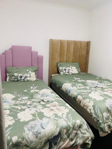 two beds sitting next to each other in a room at Lagoon Staycation in Walvis Bay