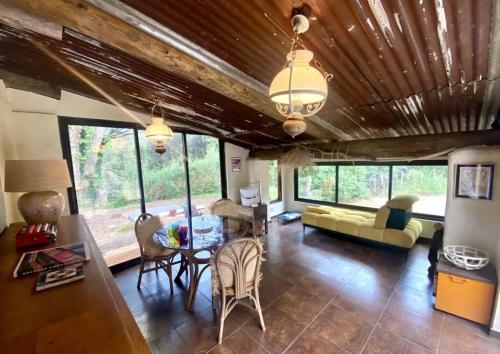 a living room with a couch and a table at La mandarine in Ramatuelle