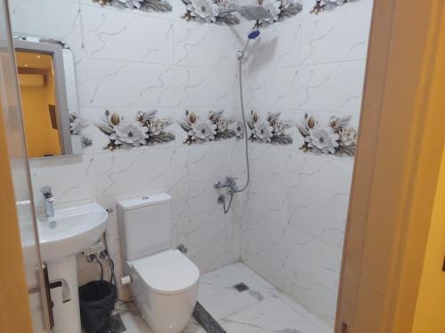 a white bathroom with a toilet and a sink at Red pyramids view hotels in Cairo