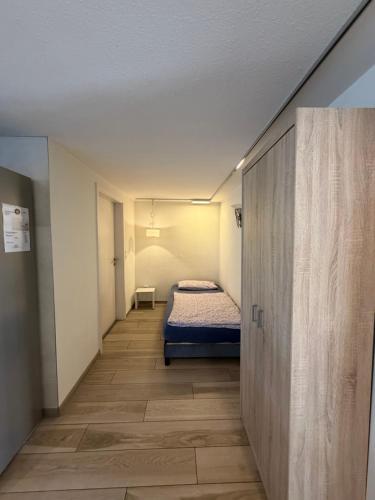 a small room with a bed and a hallway at Ferienhaus Tafolli in Linsengericht