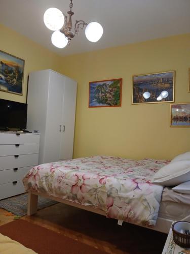 a bedroom with a bed and a dresser at Apartments Vučinović in Tivat