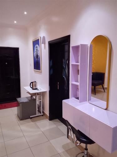 a dressing room with a mirror and a sink at Vintage classic suits in Lagos