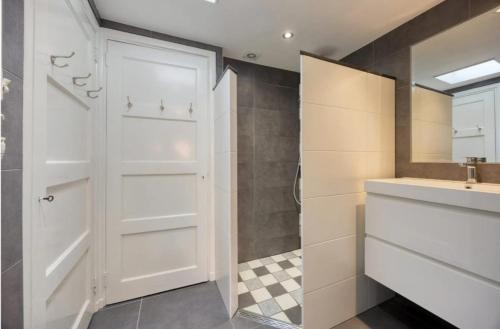 a bathroom with a white closet and a sink at Upstairs Stay Alkmaar in Alkmaar
