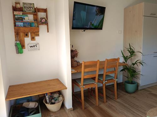 a room with a table and a chair and a television at Gravitacija East in Tolmin