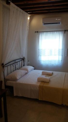 a bedroom with two beds and a window at Studio Katerina in Kimolos