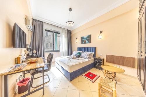 a living room with a bed and a desk at Studio en plein centre-ville, LE CENTRAL in Casablanca