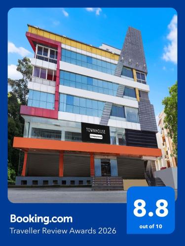 a building with a sign on the front of it at Super Townhouse Ramamurthy Nagar West Formerly Phoenix Hotel in Bangalore
