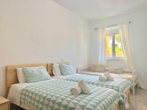 a bedroom with two beds and a window at Apartamentos Cuberris in Ajo