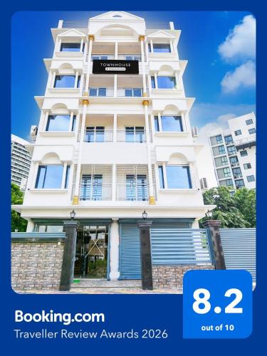 a tall white building with the words travel review rewards at Super Townhouse Rosedale Formerly Reliance Guest House in Kolkata