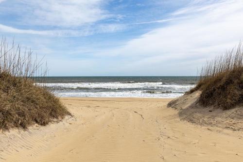 a sandy beach with the ocean in the background at DL104 - Dune's Watch in Nags Head
