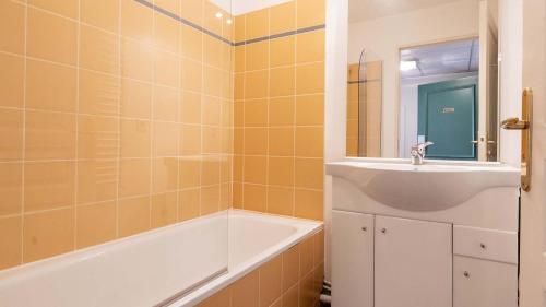 a bathroom with a tub and a sink and a bath tubermott at Virginia N309 2P4 in Grasse