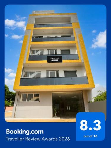 a tall apartment building with a sign on it at Super Townhouse Sector 69 Gurgaon in Gurgaon