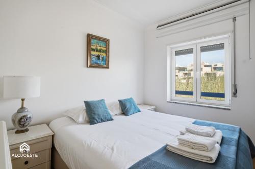 a bedroom with a white bed and a window at BC Beach House - Santa Cruz in Santa Cruz