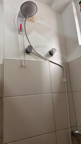 a shower head on a wall in a bathroom at Apartamento perto do HCAA - com Garagem in Santa Maria