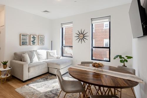 a living room with a couch and a table at Modern & Spacious 2BR Apartment with Gym & Parking in New Haven