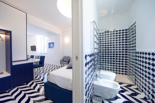 a bathroom with a bed and a sink in a room at Palazzo Sant'Elena in Anacapri