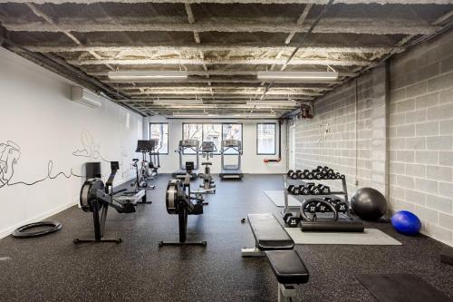 a gym with several treadmills and exercise machines at Modern & Spacious 2BR Apartment with Gym & Parking in New Haven