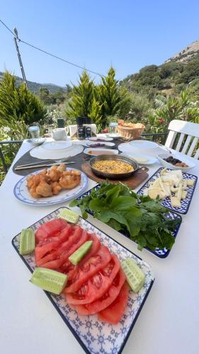 a table with plates of food on top of it at Son Vapur Otel in Gökçeada