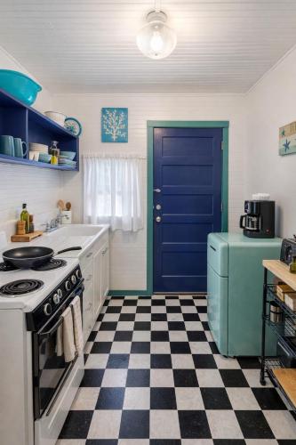 a kitchen with a blue door and a checkered floor at Cabin in Tybee Island, Georgia in Tybee Island