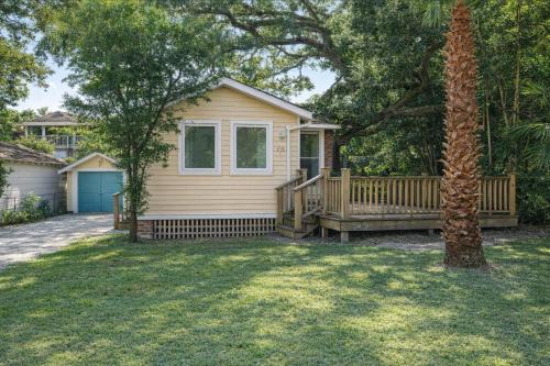 a house with a porch and a tree at Cabin in Tybee Island, Georgia in Tybee Island