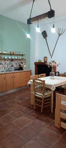 a kitchen with a table and wooden cabinets at El Rincón de Ani in Torres