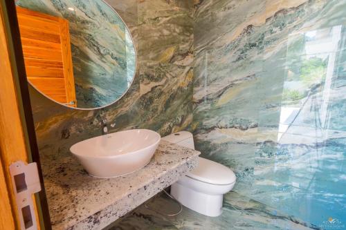 a bathroom with a sink and a toilet at Villa Babylon Chaweng in Koh Samui