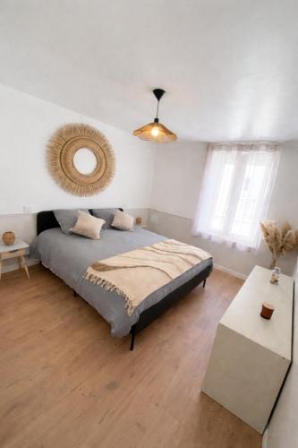 a bedroom with a bed and a mirror on the wall at L'échappée belle, en Champagne in Dormans
