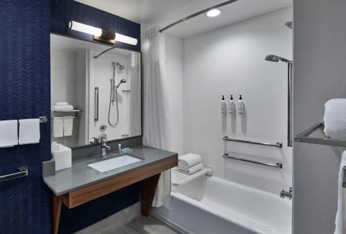 a bathroom with a sink and a tub and a shower at Fairfield by Marriott Inn & Suites LaGrange in La Grange