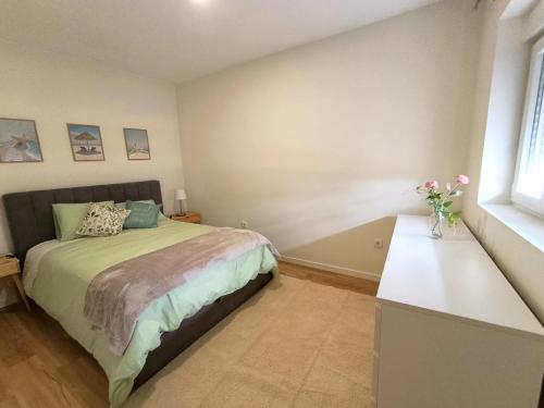 a bedroom with a bed and a vase of flowers at Casa Serra & Mar in Azeitao