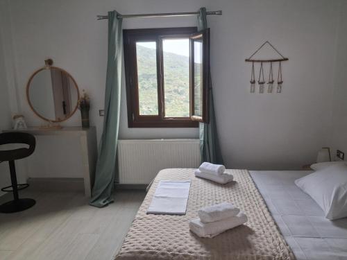 a bedroom with a bed with two towels on it at Villa Elia in Kástron