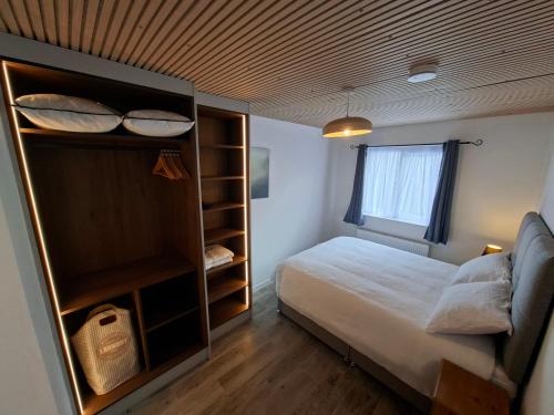 a small bedroom with a bed and a window at Derryhick Escape in Crillaun