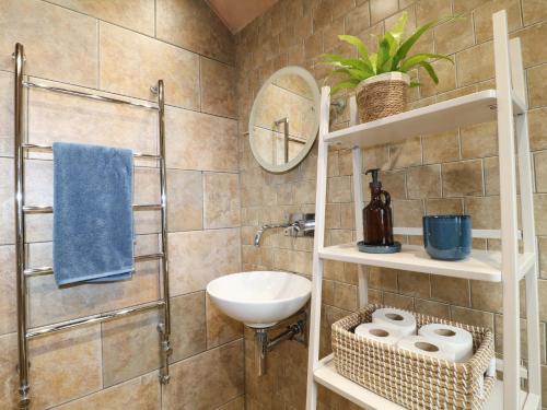 a bathroom with a sink and a mirror at Lumford Mill Cottage in Bakewell