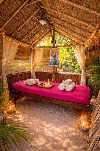 a bed in aentedented room in a resort at Le Moya Beach in Nosy Be