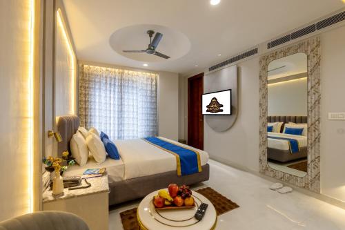 a hotel room with a bed and a mirror at Hotel Anu Plaza - Newly Built Hotel With Parking Just 6 Mins from Connaught Place ,New Delhi Railway Station & Metro Station in New Delhi