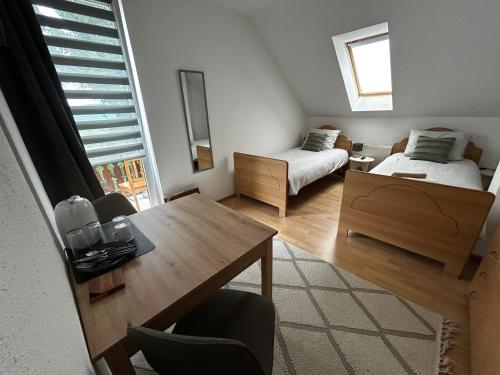 a living room with a table and a bed and a bedroom at Villa van Dam in Miłków