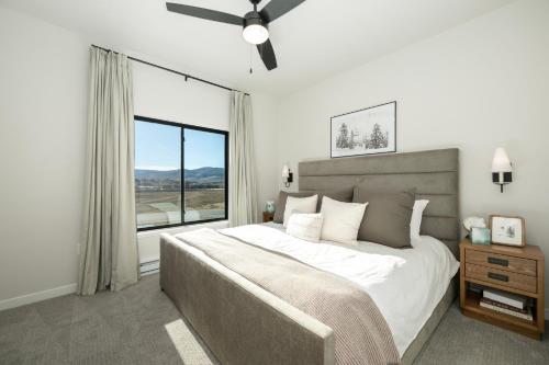 a bedroom with a large bed and a large window at 103 Granby Meadow Dr in Granby