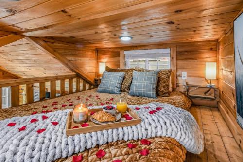 a bedroom with a bed with a tray of food on it at Sojourn Lodging in Sevierville