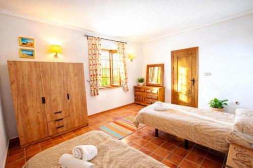 a bedroom with two beds in a room at La Casona del Olivo - Pool, Patio, BBQ & Pet-Friendly in Torre-Pacheco