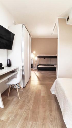 a bedroom with a bed and a desk and a desk at Hotel Aria di Mare Bed & Breakfast & Beach in centro a Riccione in Riccione