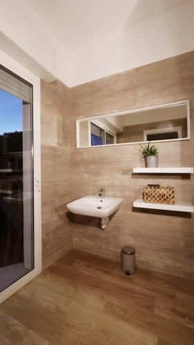 a bathroom with a sink and a window at Hotel Aria di Mare Bed & Breakfast & Beach in centro a Riccione in Riccione