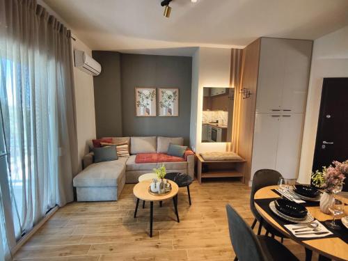 a living room with a couch and a table at Sandy'sLuxuryApartment in Alexandroupoli
