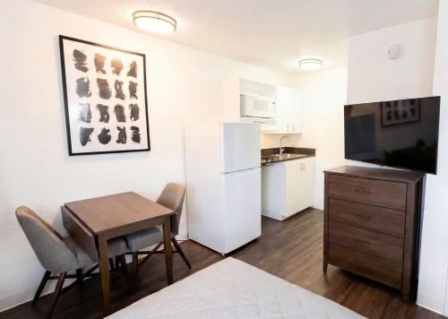 a small kitchen with a table and a kitchenette with a small table at InTown Suites Extended Stay Louisville KY - Preston Hwy in Louisville