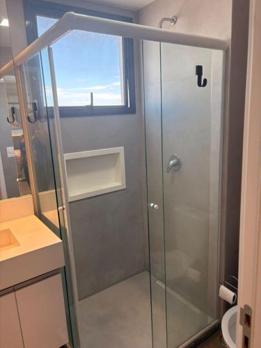 a shower with a glass door in a bathroom at Apartamento Studio in Arujá