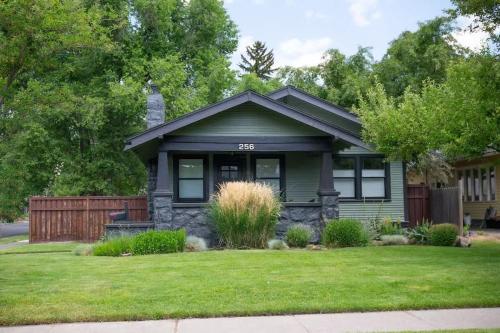 a small green house with a grass yard at The Modern Cottage in Bend