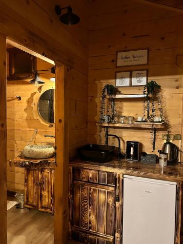 a kitchen with wooden cabinets and a counter top at Maysa Suit Bungalov in Çamlıhemşin