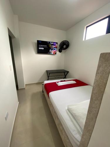 a small white room with a bed in it at Apartamento Tercer Cielo 203 in Cúcuta
