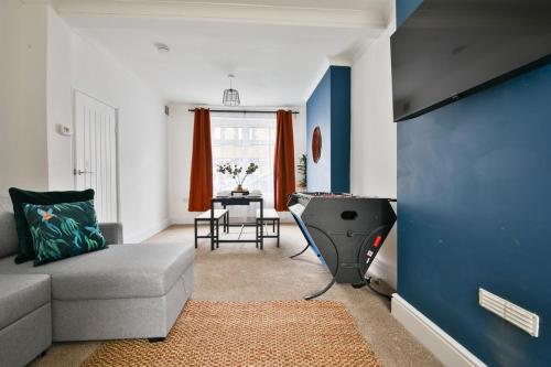 a living room with a couch and a table at Cosy 3-Bedroom House Near Caerphilly Castle in Caerphilly