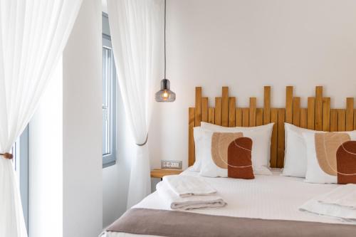 a bedroom with a bed with a wooden headboard at Almyra House in Adamantas