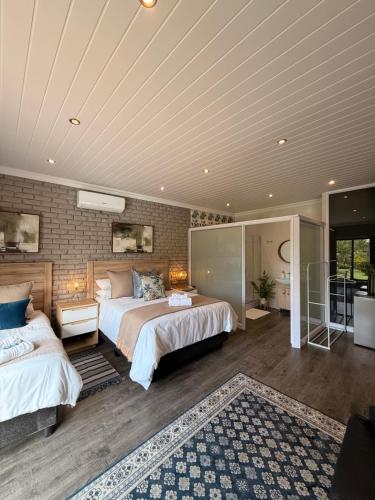 a large bedroom with two beds and a rug at Lemon & Blue Guest House in Welkom